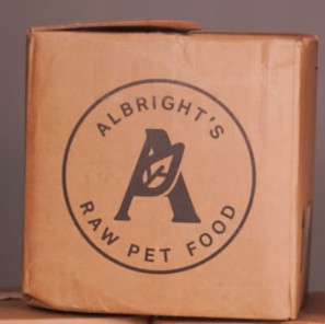 Cardboard box with Albright's Raw Pet Food logo