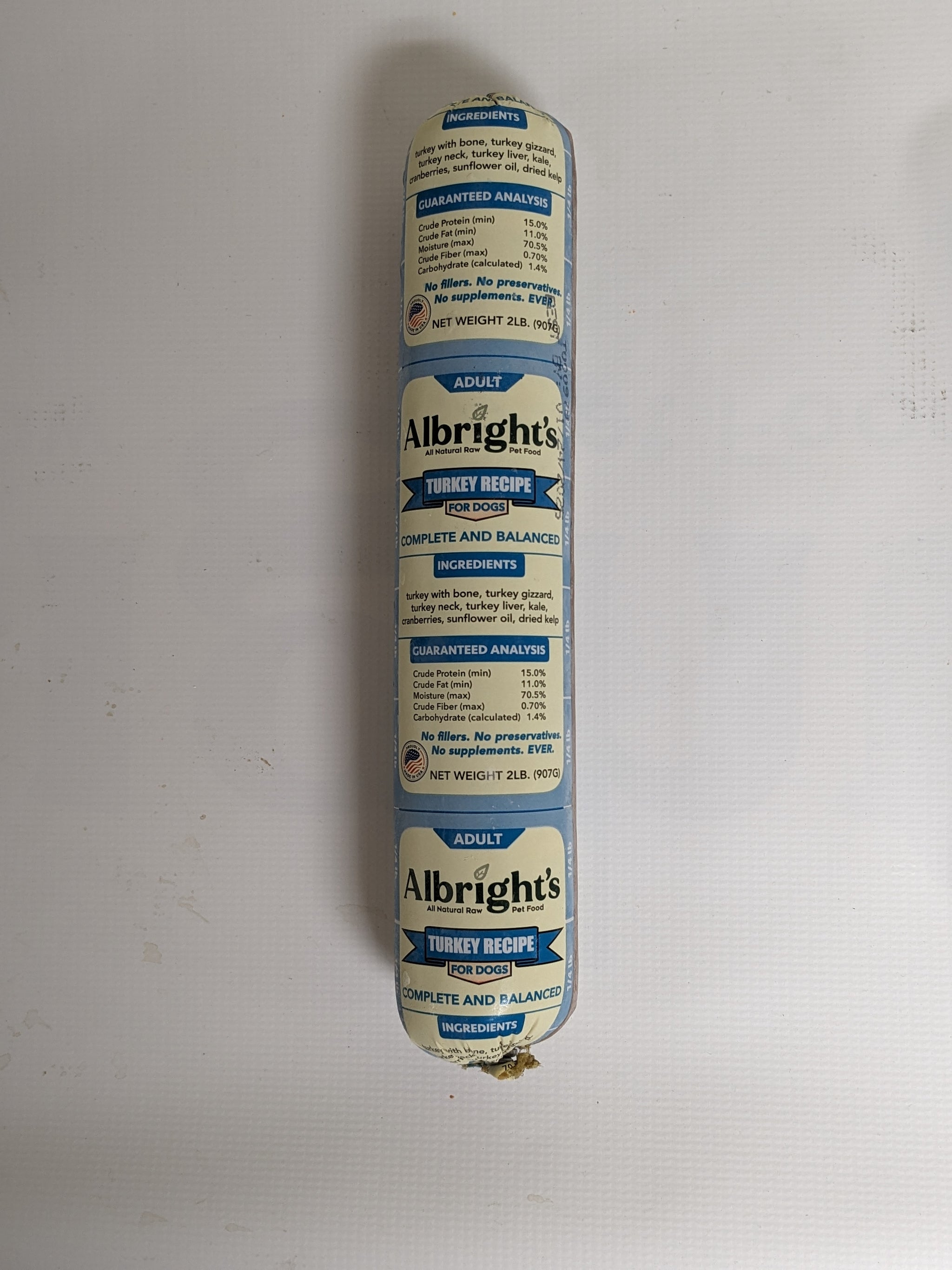 Albrights Raw Dog Food Turkey 2lb roll with a label on a white background