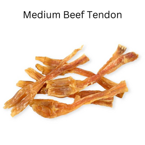 Dried beef tendon strips scattered on a white background, representing a natural and protein-rich dog treat.